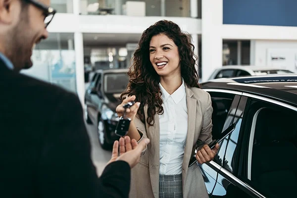Customer Handing Car Keys to a Dealership Salesperson.